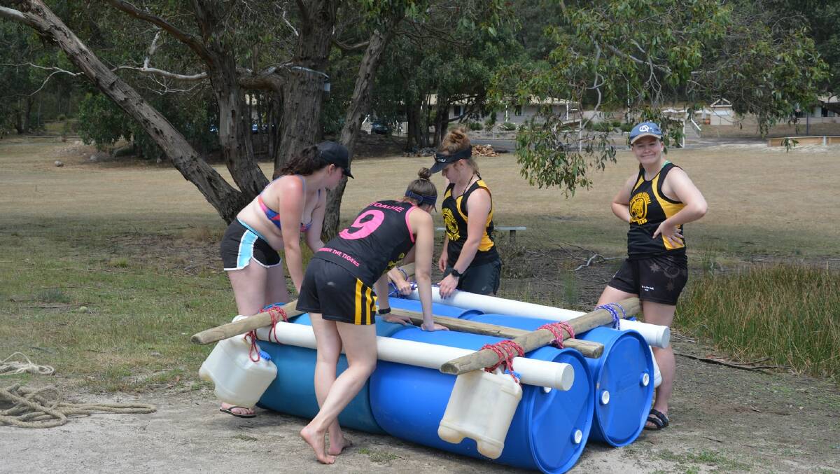 Kyneton players undertake a raft bulding exercise during a pre-season training camp.