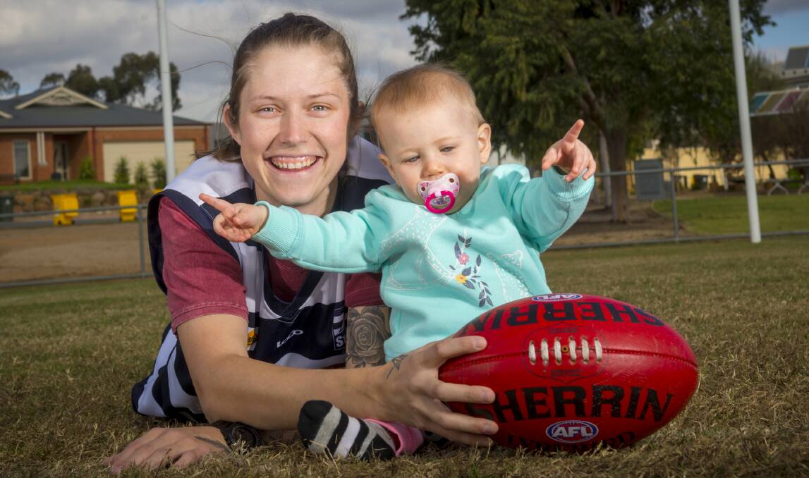 GOAL: Storm star Britney Mueck with 10-month-old daughter Lenni. Mueck is currently the CVFLW's leading goal kicker. Picture: DARREN HOWE