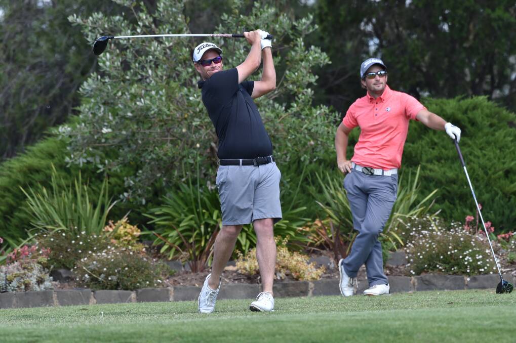 Kris Mueck watches on as Andrew Martin drives a ball down the seventh fairway at the Belvoir Park Golf Club Christmas Bonanza in December 2018. Picture: GLENN DANIELS
