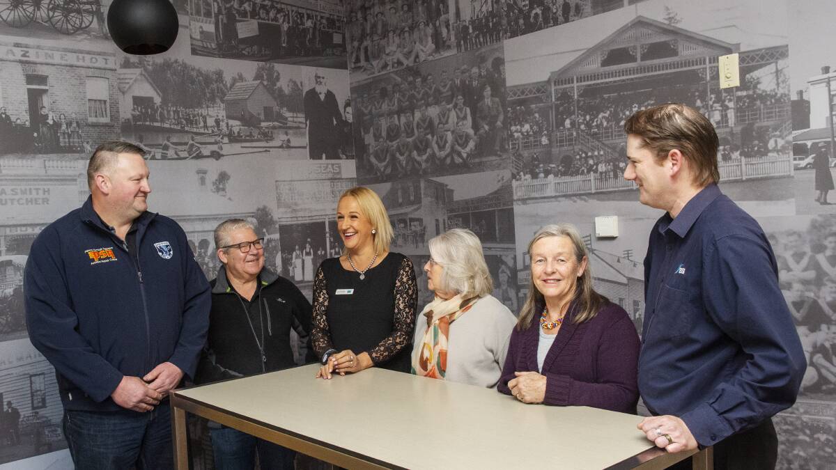 SHARING HISTORY: Andrew Reid, Steve Bright, Aylene Kirkwood, Mary Preston and Borough Club staff marvel at the new wall.