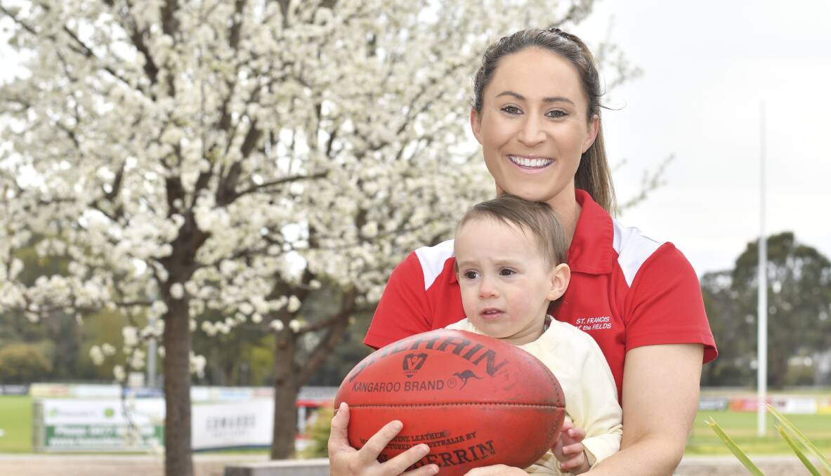AWARD WINNER: Danielle Coates loves inspiring children to be their best as sportspeople, which one day will include her daughter Caidie Coates. Picture: NONI HYETT