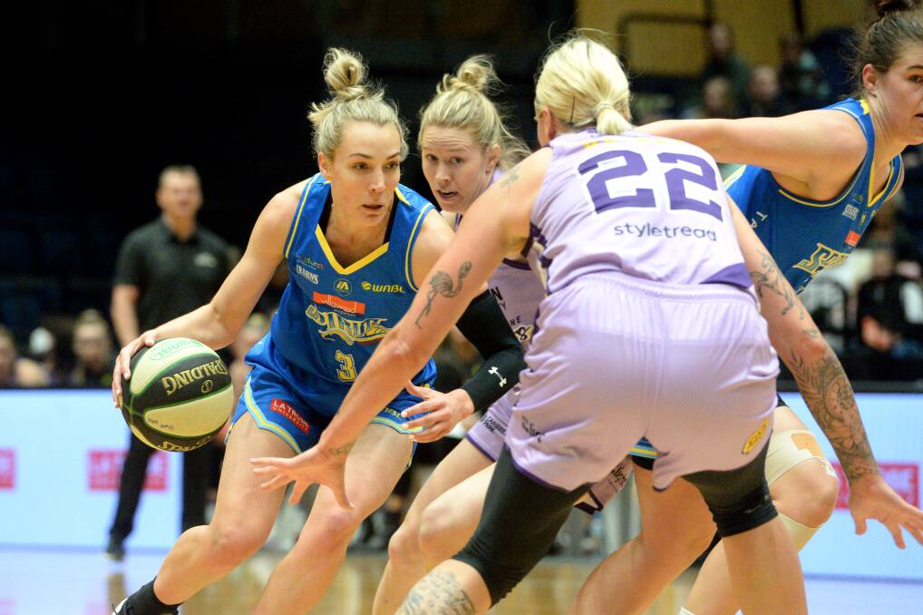 Maddie Garrick looks for options to get around Boomers' forward Cayla George. Picture: DARREN HOWE