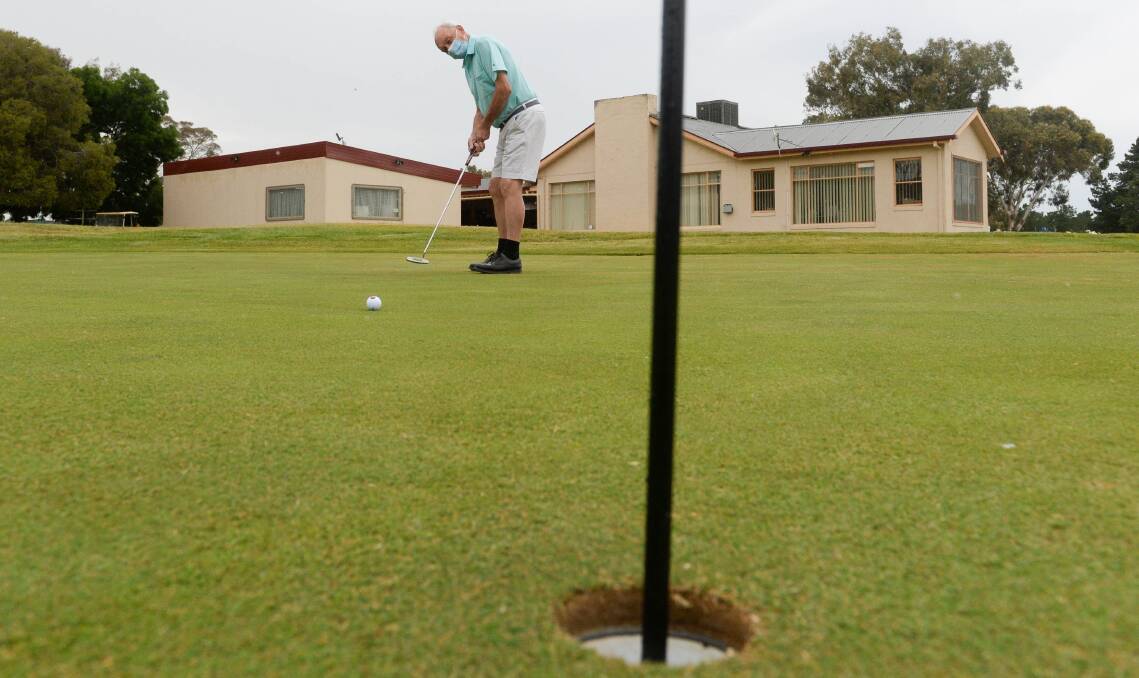 PRACTICE: Brian Harding warms up his putter before a round at Belvoir Park Golf Club. Picture: DARREN HOWE