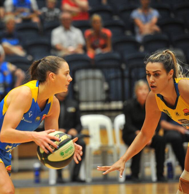 NEW SIGNING: Alex Wilson (right) faces off with Tessa Lavey while playing for the Sydney Uni Flames during the 2019/20 WNBL season.
