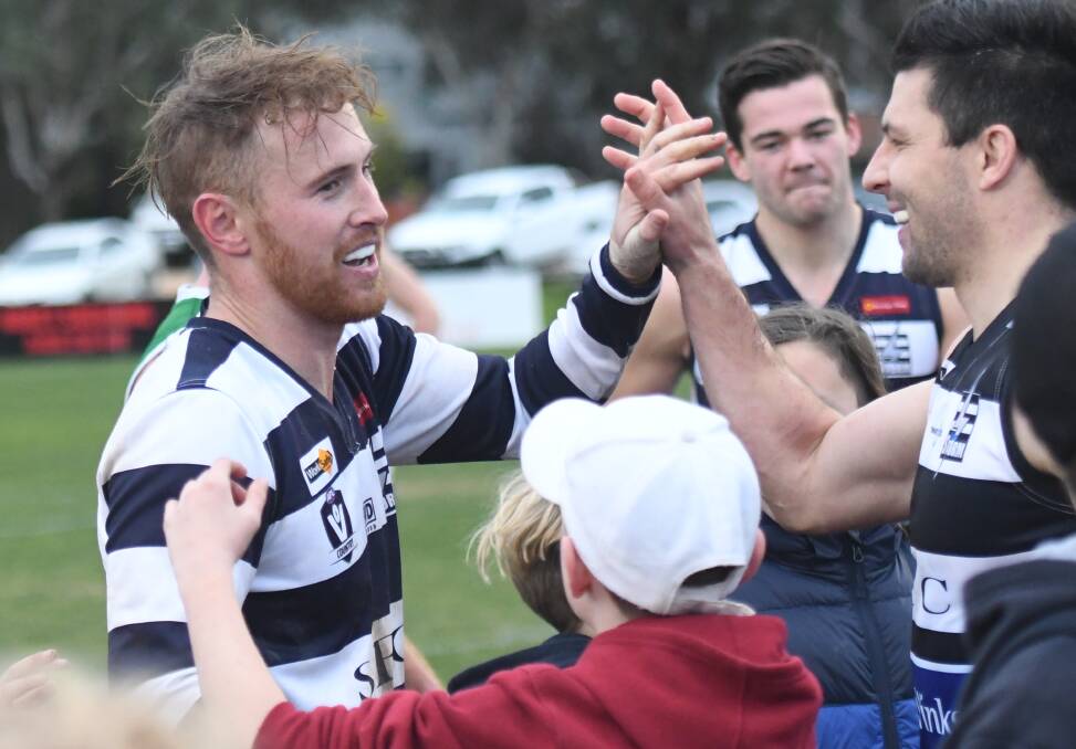 CELEBRATIONS: Storm captain Kallen Geary congratulates Lachlan Sharp on his 100th season goal milestone during the team's win over Kangaroo Flat at Tannery Lane. Sharp kicked a total of 11 goals during the game. Picture: ANTHONY PINDA 