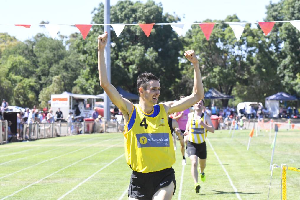 JUBILATION: Michael Preece celebrates as he crosses the line first in the 1600m Open final at the 2020 Maryborough Highland Gathering at Princes Park. Picture: NONI HYETT