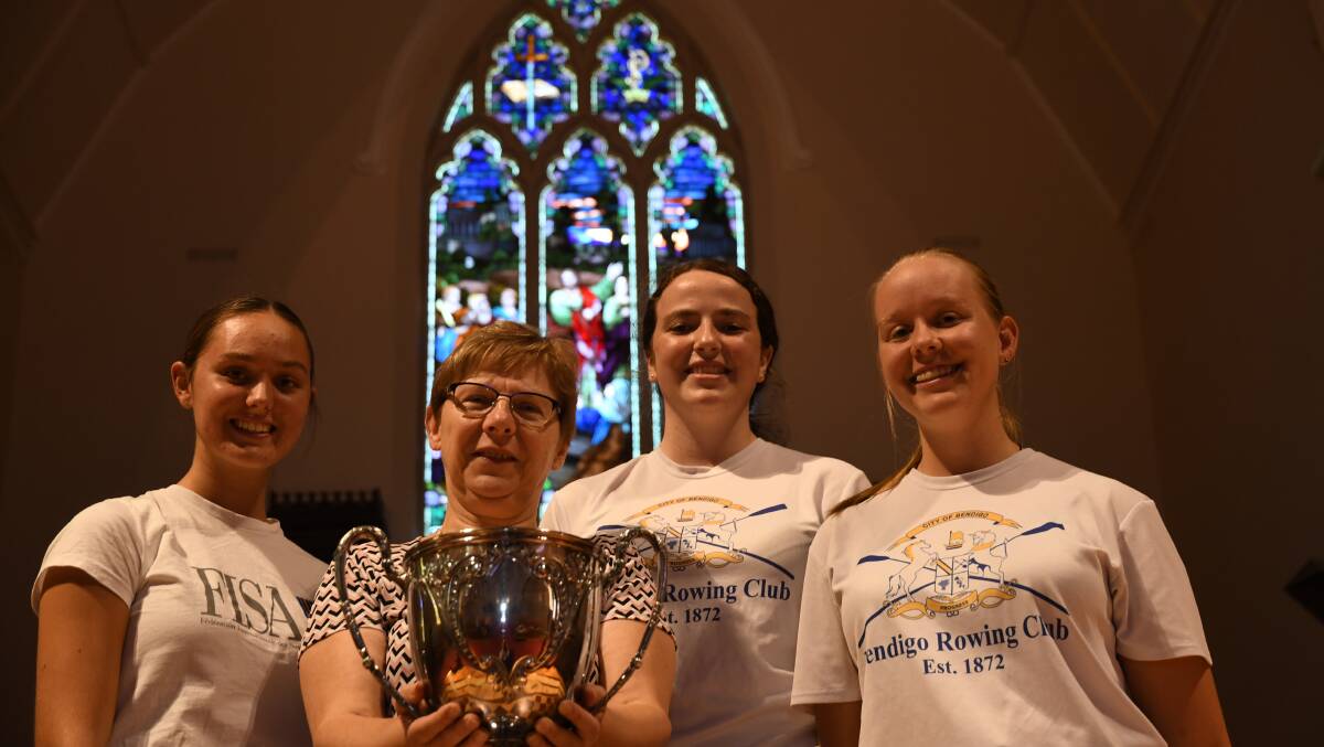 HANDLING HISTORY: St Paul's Cathedral dean Elizabeth Dyke with Bendigo Rowing Club members Pip Robertson, Neve Coleman and Amy Morgan. Picture: ANTHONY PINDA