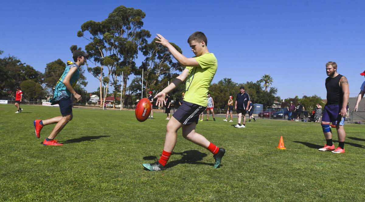 FUNDAMENTALS: Participants undertook several football drills at the Bendigo Suns come and try day. Picture: NONI HYETT