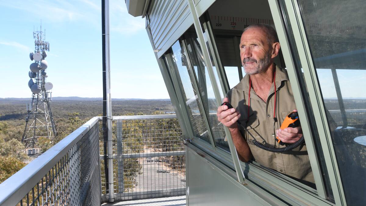 LOOK-OUT: One Tree Hill fire tower observer Daryl Anderson on patrol for any developing fires. Picture: NONI HYETT.