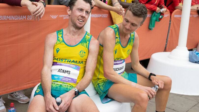 FRIENDS: Liam Adams and Andy Buchanan soak up the atmosphere after the Commonwealth Games men's marathon. Picture: ATHLETICS AUSTRALIA