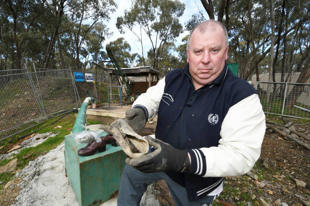 LOOKING FOR ANSWERS: Daryl Floyd with a shoe discovered during a search of the Morning Star Mine at Avoca. Picture: Lachlan Bence