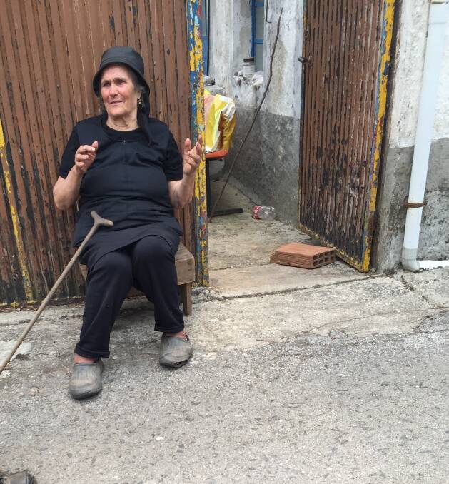 Liveliehood lost: Dona Estrela, nearly 80, weeps outside her home.