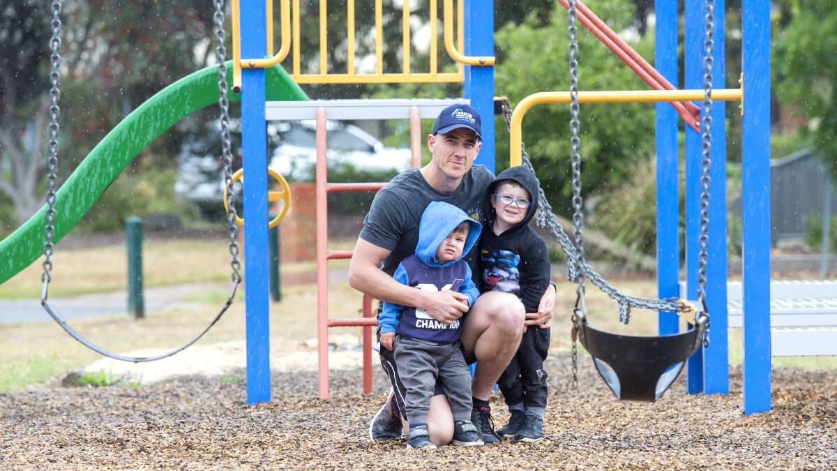 Lachlan O'Toole with his sons Cooper and Ollie at the Melbury Court playground. Picture: DARREN HOWE