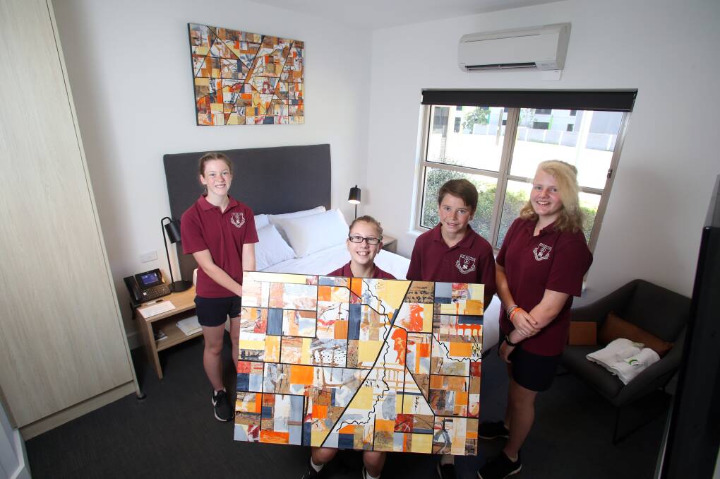 Rochester Secondary College students Josephine Brown, Aylee Treacy, Kody Lees, and Isabella Mirikli with their artworks that will hang to Bendigo Bank House patient accommodation. Picture: GLENN DANIELS