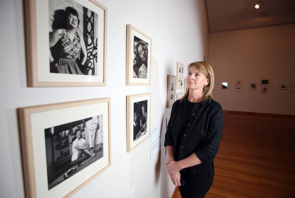 VISUAL: Bendigo Art Gallery senior curator Leanne Fitzgibbon admires some of the photos in the Frida Kahlo exhibition, whihc has been popular this holidays. Picture: GLENN DANIELS