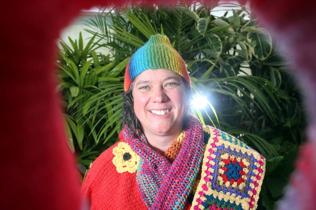 WARM: Ros Abercrombie with a few of the 700 scarves knitted for Artlands Victoria. Picture: GLENN DANIELS