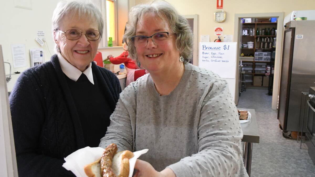 Barbara Simpson and Sandy Birch with a vegan sausage at St Paul's.