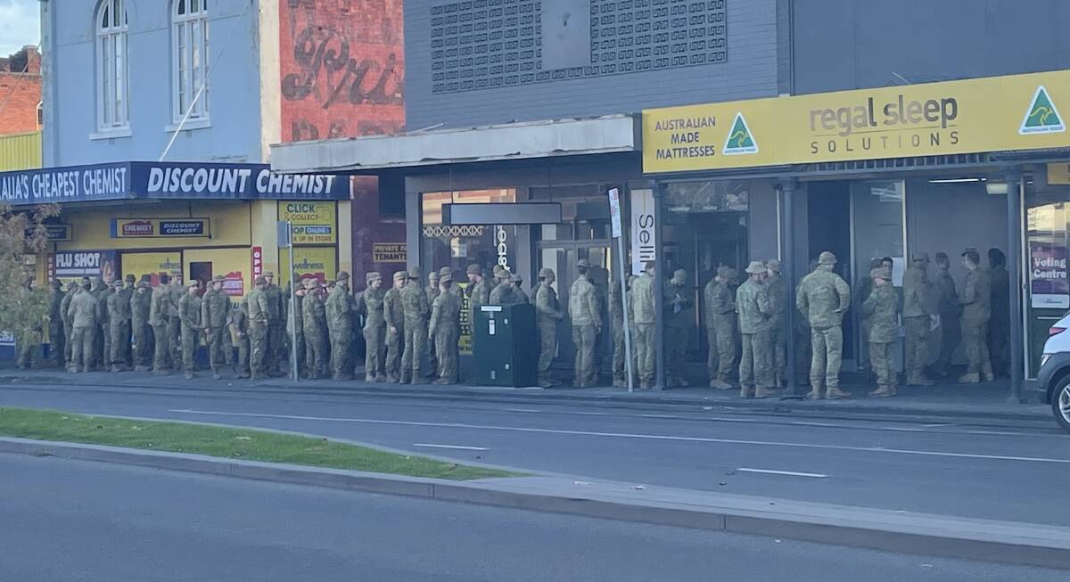 ADF members wait for polls to open in Mitchell Street. Picture: CHRIS PEDLER