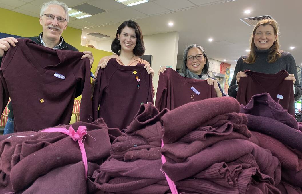 Girton parent John Thomas, Sister Works Bendigo hub leaders Leah Sigley and Ginny Tan and Girton parent Kate Mahoney with the 40 former school jumpers donated to the Bendigo Winter Night Shelter. Picture: CHRIS PEDLER