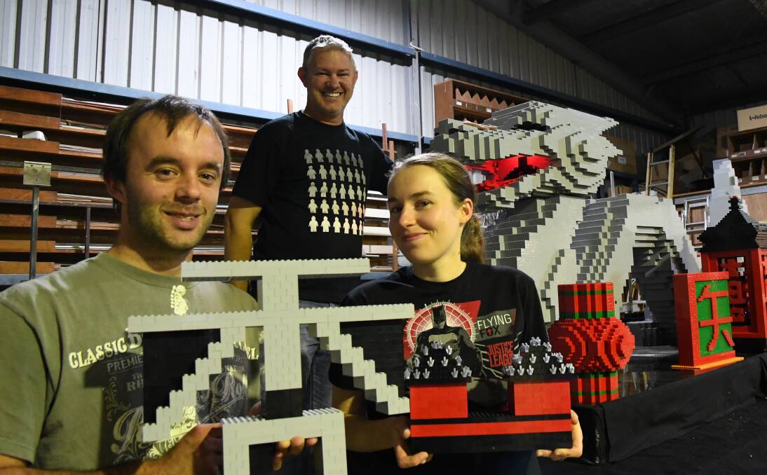 Ben Ludington, Michael Peebles and Kara Harris work on the Bendigo Lego User Group's parade float.