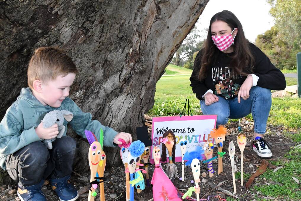 NEW SUBURB: Jensen Corbett and teacher Maddy Vernon inspect the growing town of Spoonville near Cooinda Park in Golden Square. Picture: NONI HYETT