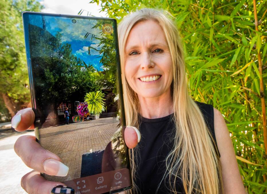 DIGITAL GALLERY: Artist Kim Lowe at the Golden Dragon Museum with some of the augmented reality art that is part of Bendigo Art Trail app. Photo: Brendan McCarthy 