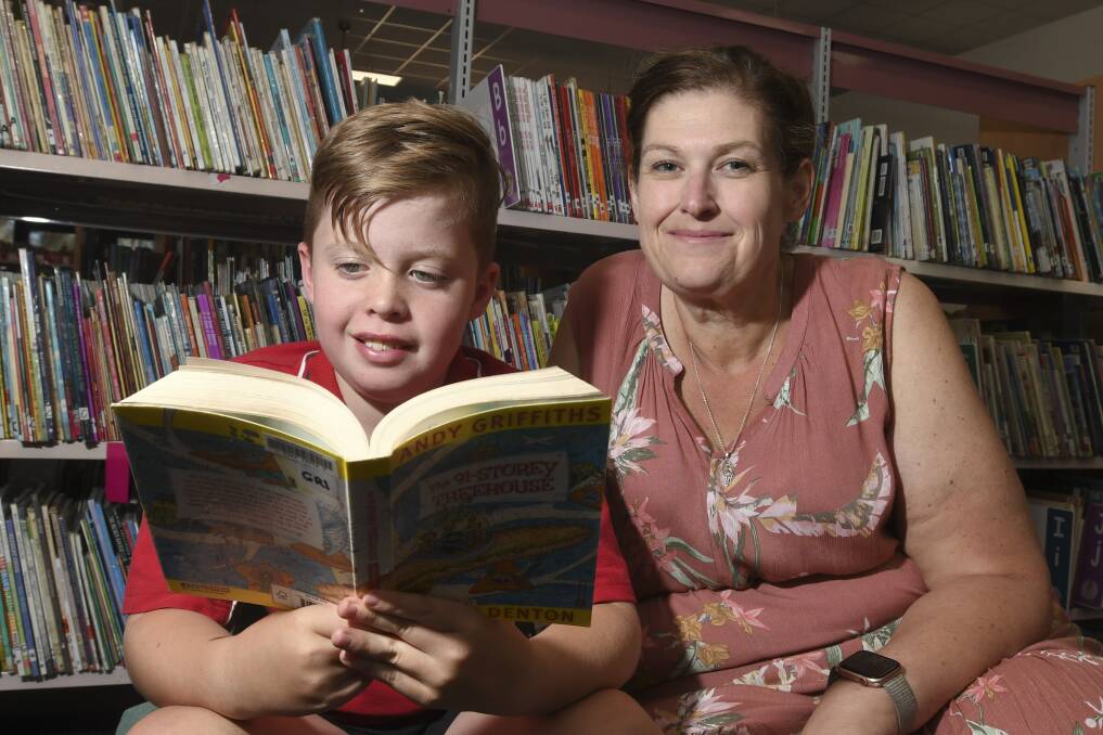 READING CHALLENGE: Miller Evans reads on of his favourite books with Epsom Primary School teacher teacher Kylie Warfe. Picture: NONI HYETT