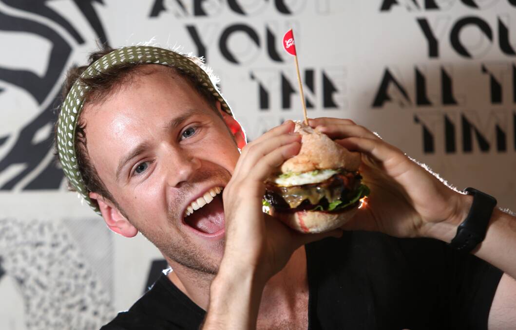Ryan Holt from Grill'd Bendigo tucks in to a burger.