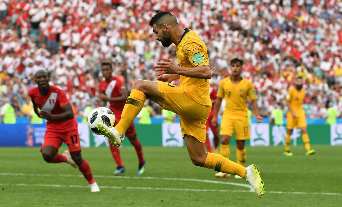 Australia's Aziz Behich looks to cross to Tim Cahill during their final World Cup match against Peru. Picture: AAP Image/Dean Lewins