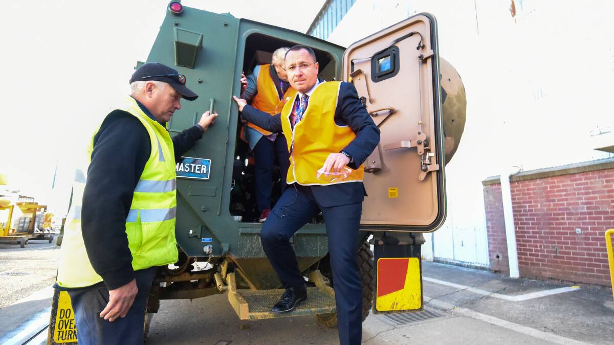 THANKFUL: Ukrainian Ambassador to Australia Vasyl Myroshnychenko exits one of the Bushmasters during his tour. Picture: DARREN HOWE