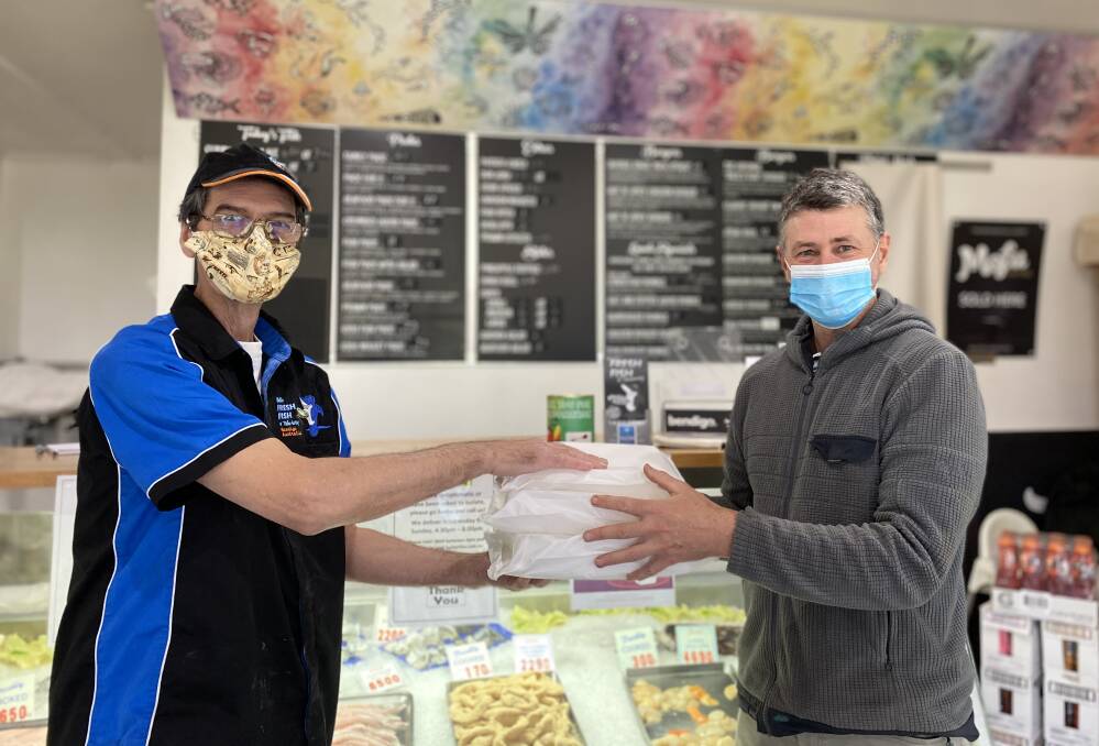 GENEROUS: Mick's Fresh Fish and Takeaway owner Mick Kimpton and dinner voucher recipient Adrian Martins. Mick was one of 40 hospitality traders part of Bendigo's Biggest Takeaway. Picture; CHRIS PEDLER