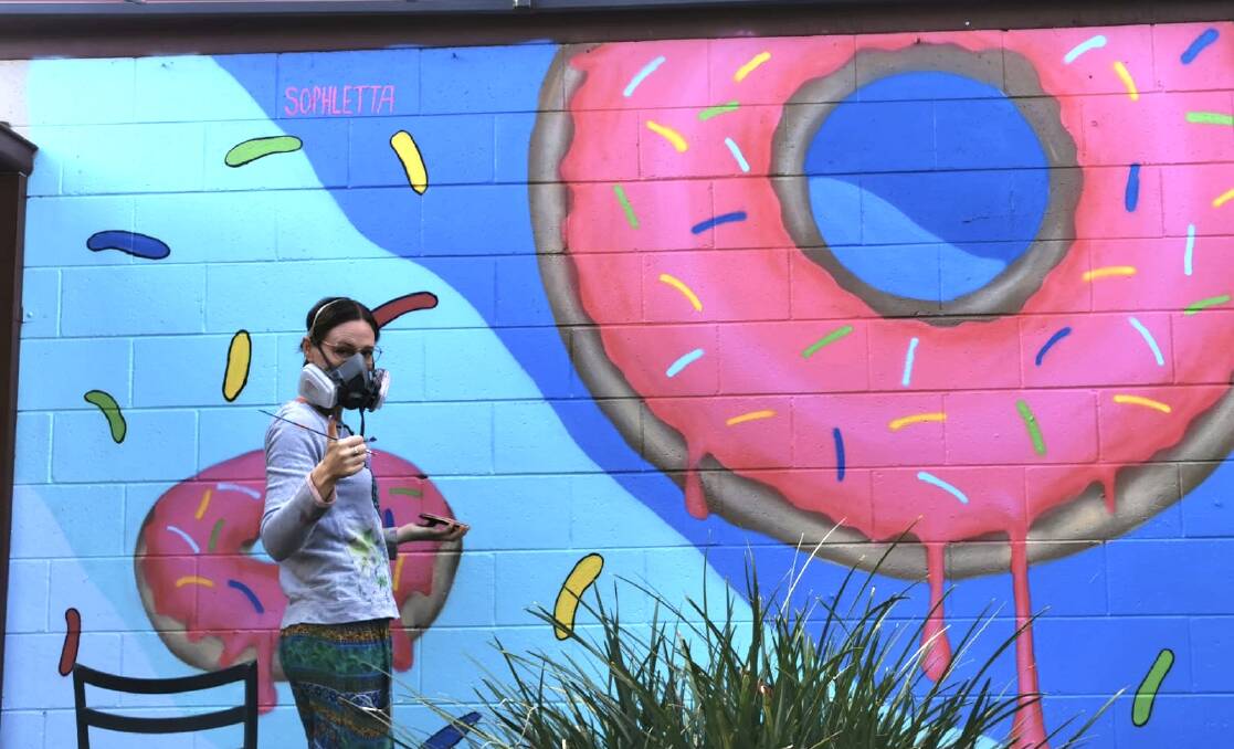 THUMBS UP: Tongala artist Sophie Wilson completed a new mural on the side of the Elmore Bakery last weekend. Pictures: SUPPLIED