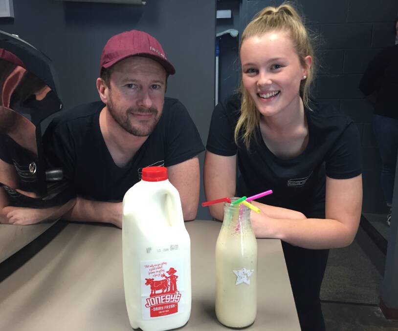 CHEERS: Boris Murgers owner Paul Morris and staff member Kayley Stewart serve up a milkshake. Picture: CHRIS PEDLER