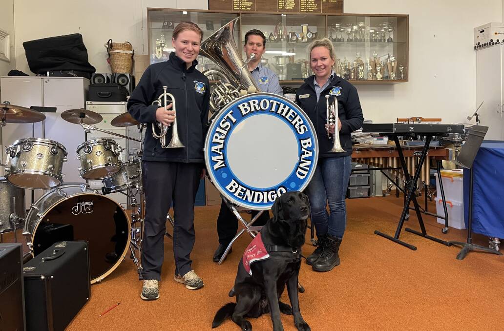 BRINGING THE BRASS: Marist Brass Band members Rachael Hamilton, Aidan Ratcliff and president Sally Spark with assistance dog River will take to The Capital stage this week. Picture: CHRIS PEDLER