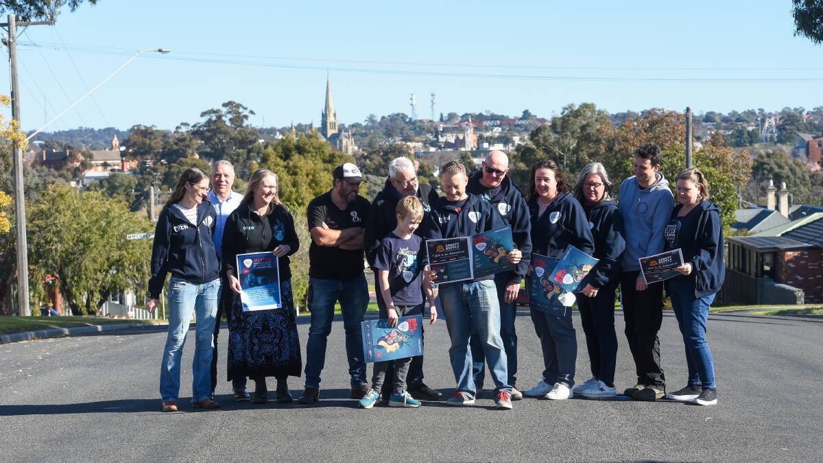 FINAL NOTE: Colin Thompson (centre with program) and other Bendigo Blues and Roots Festival volunteers. This year's festival will be its last. Picture: DARREN HOWE