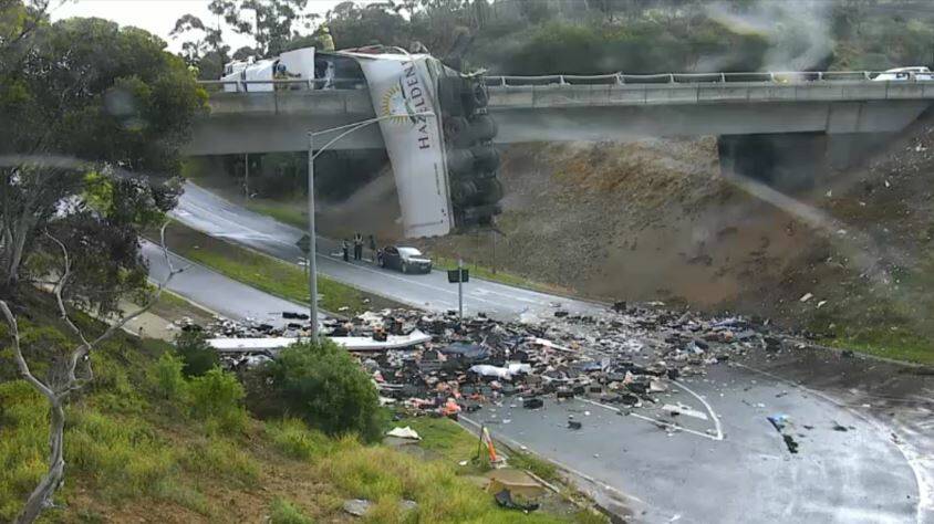 A B-double truck was left hanging from an overpass on the Calder Freeway this evening. Picture: VicRoads