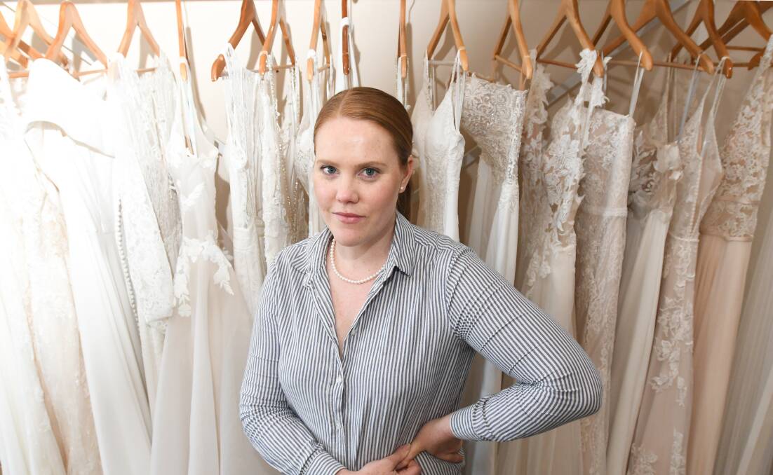 DRESS DEMAND: Fifi&Edga owner Catherine Anyon has seen a dramatic decline dresses being ordered as brides postpone their weddings. Picture: NONI HYETT