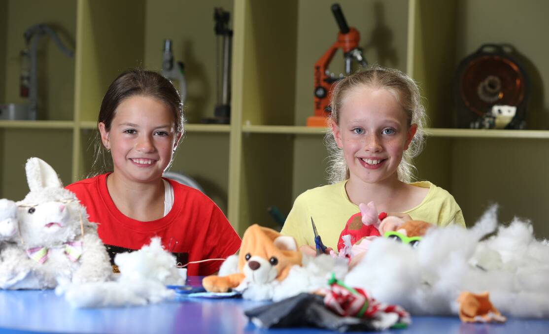 EAGER TO LEARN: Kyra Hourigan and Hannah Miller were two of more than 40 home educated students at the Discovery Centre on Wednesday. Picture: GLENN DANIELS