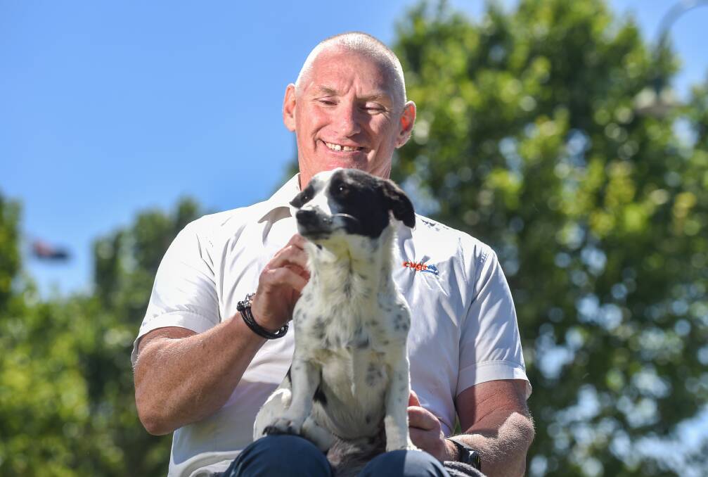 ALL SMILES: CVGT's Michael Taylor and his mate Spike. Michael returned to work two years ago. He was paralysed in a hit-and-run accident in 2003. Picture: DARREN HOWE