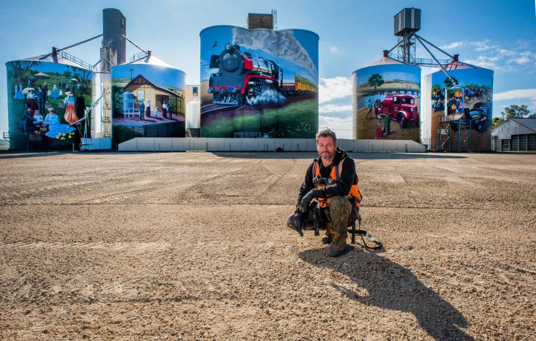 PROJECT: Artist Tim Bowtell with five of the six silos he has worked on in Colbinabbin. 