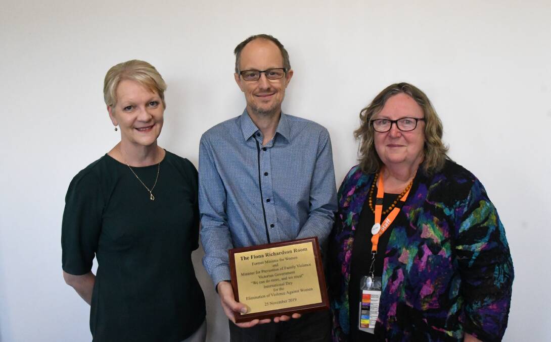 Fiona Richardson's colleague, Bendigo West MP Maree Edwards, husband Stephen Newnham and Annie North CEO Julie Oberin with the plaque that will hang in the meeting room named in her honour. Inscribed on it is a quote: "We can do more, and we must".