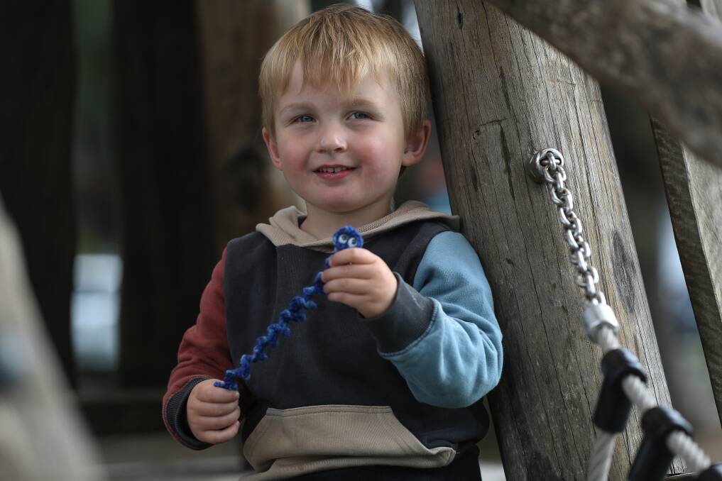 DAY BRIGHTENED: Samuel Kerr, 3, with the 'worry worm' he found in Kanahooka Park, left by a crafty and kind stranger. Picture: Robert Peet