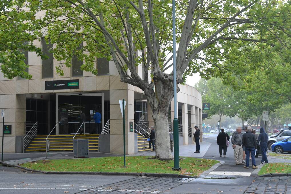 People waiting outside the Bendigo Centrelink offices earlier this year. Picture: NONI HYETT
