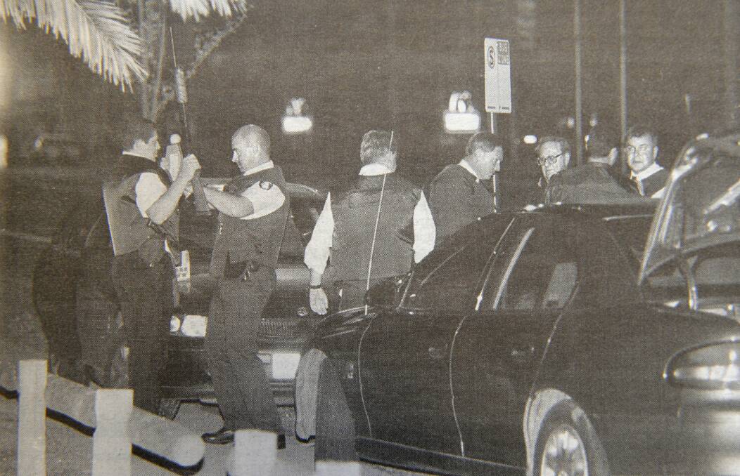 Officers prepare themselves at the scene of the siege.