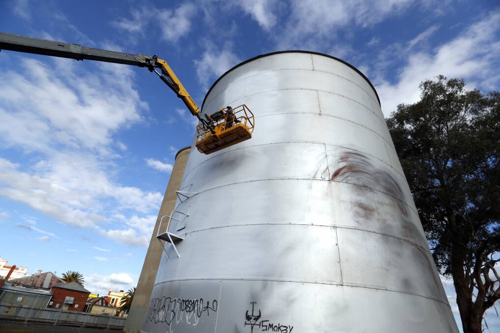 Artist Jimmy DVate begins painting the Rochester silo. Picture: GLENN DANIELS