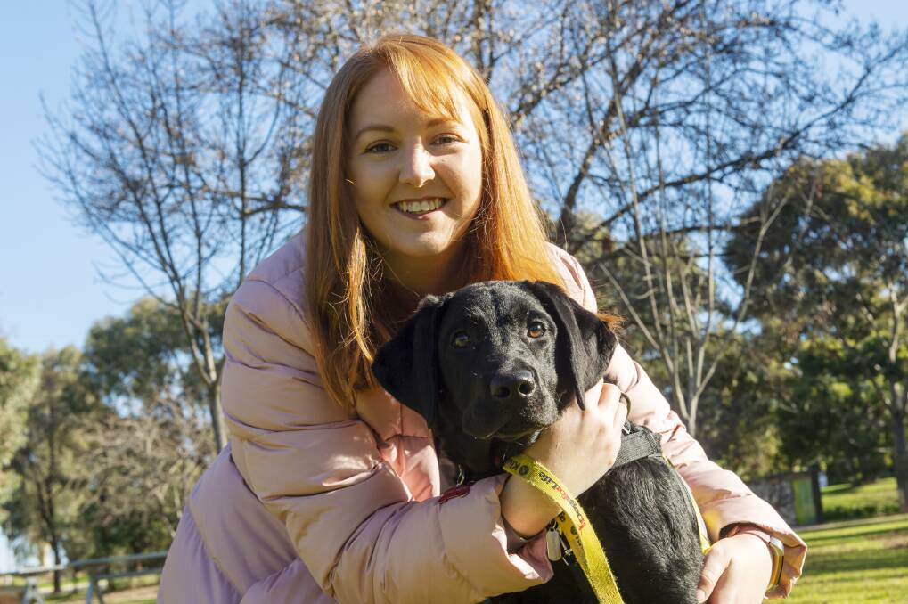 La Trobe University student Sarah Postlethwaite with assistance dog-in-training Rosie. Picture: DARREN HOWE