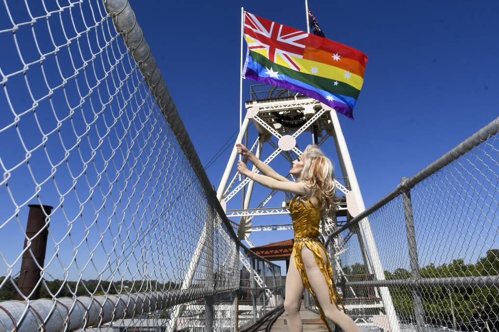 Bendigo PRIDE Festival ambassador Deborah Triangle raising the rainbow flag earlier this year. Picture: NONI HYETT
