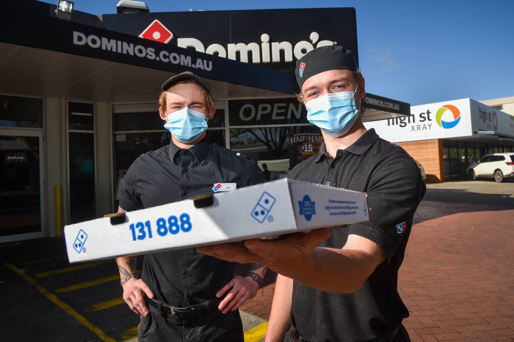 Jack Collins and Ben Ridges from Domino's Bendigo, where $1 from every pizza sold on Friday will go to the family of a seriously injured man. Picture: DARREN HOWE