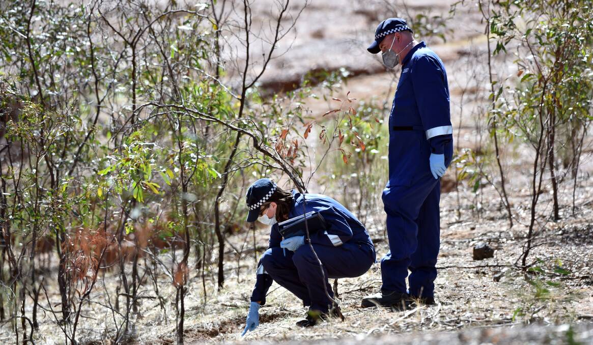 CRIME SCENE: Investigators at the site where Samantha Kelly's body was left. Her former housemates Christine Lyons and Ronald Lyons have pleaded not guilty to her murder and attempted murder. Picture: GLENN DANIELS