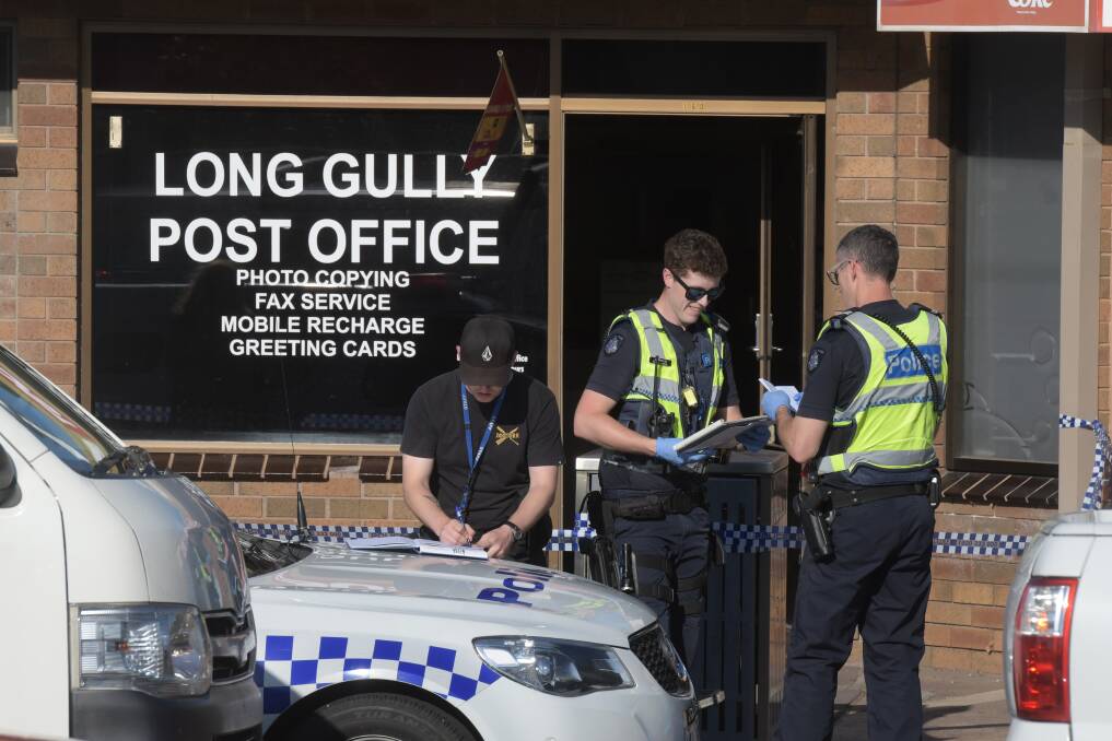 Police at the scene of the attempted armed robbery last year. Picture: NONI HYETT